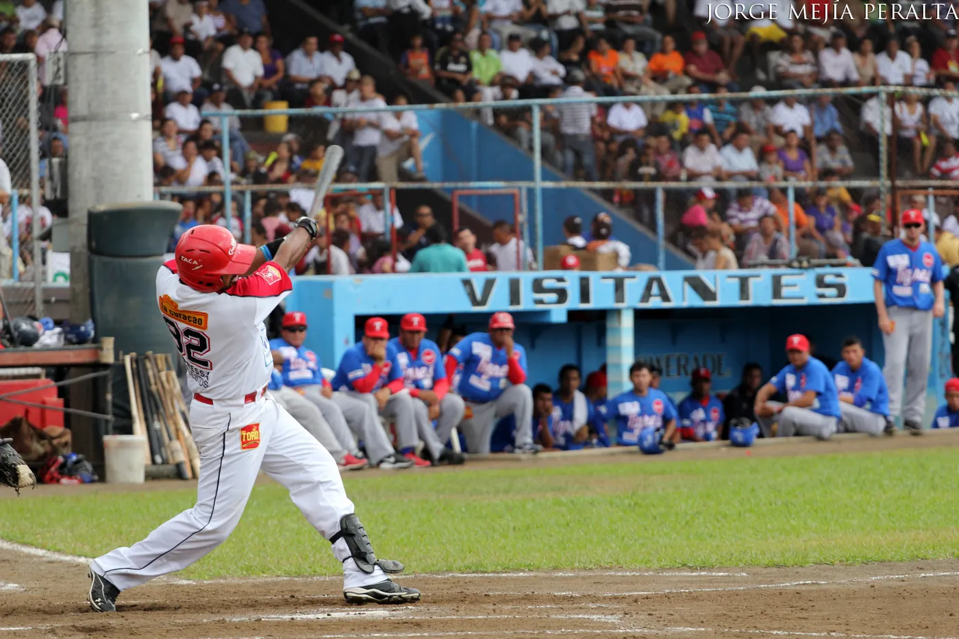 A baseball game under floodlights with players on the field