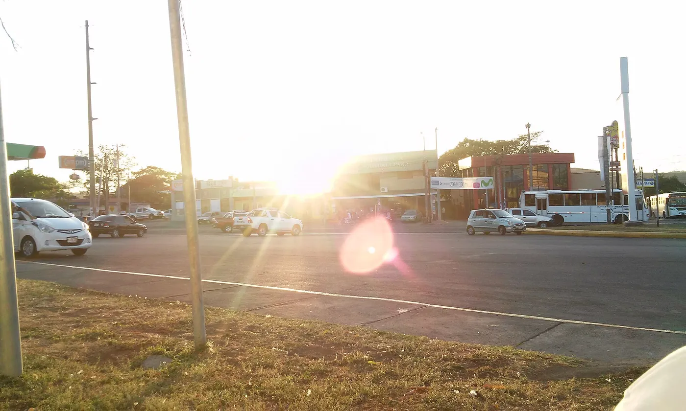 A neighbourhood street in Managua with shops and trees